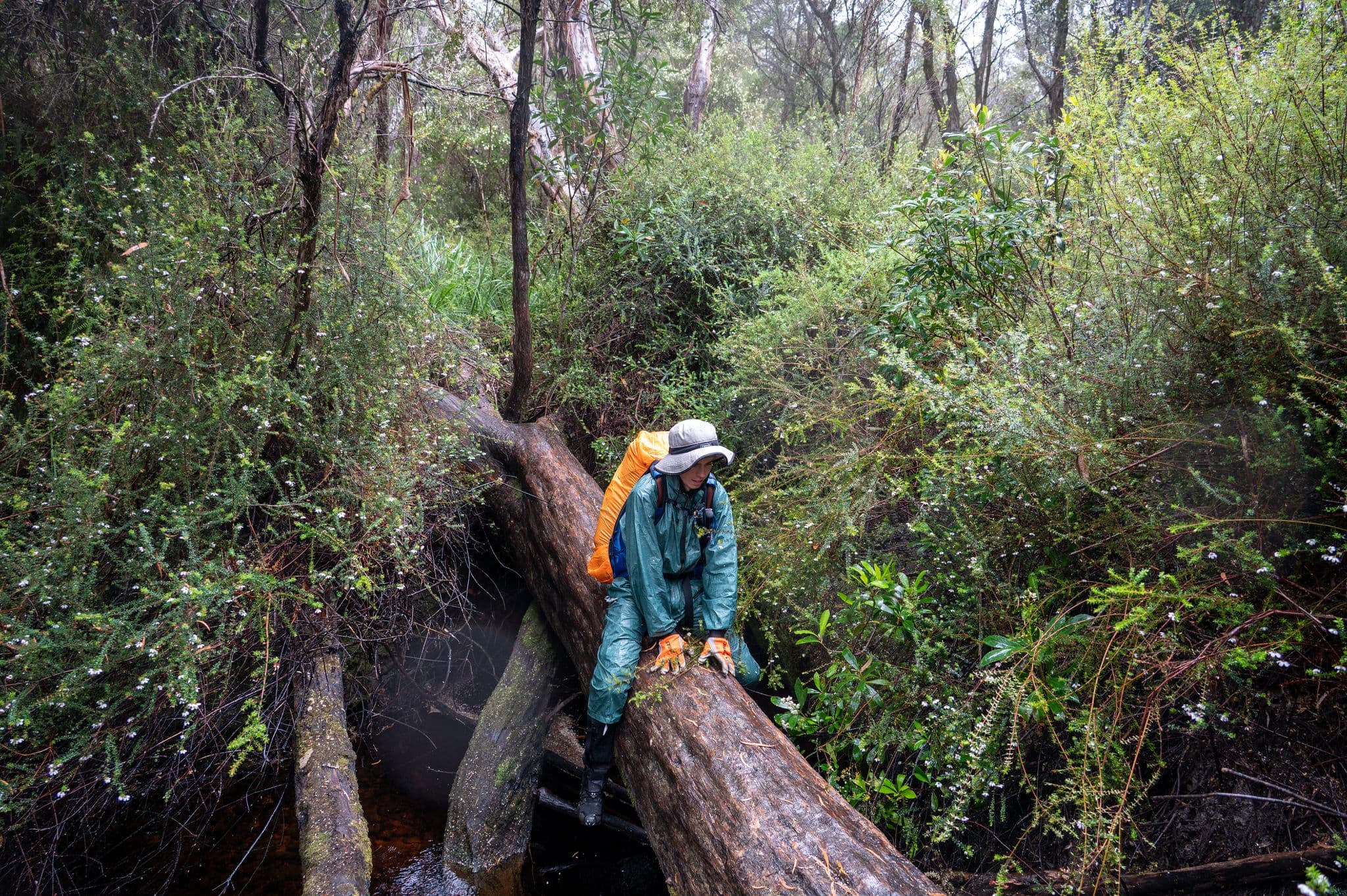 Scooting across Wullyawa creek. The heavy rain made walking on it too slippery. Photo Credit - Craig Pearce