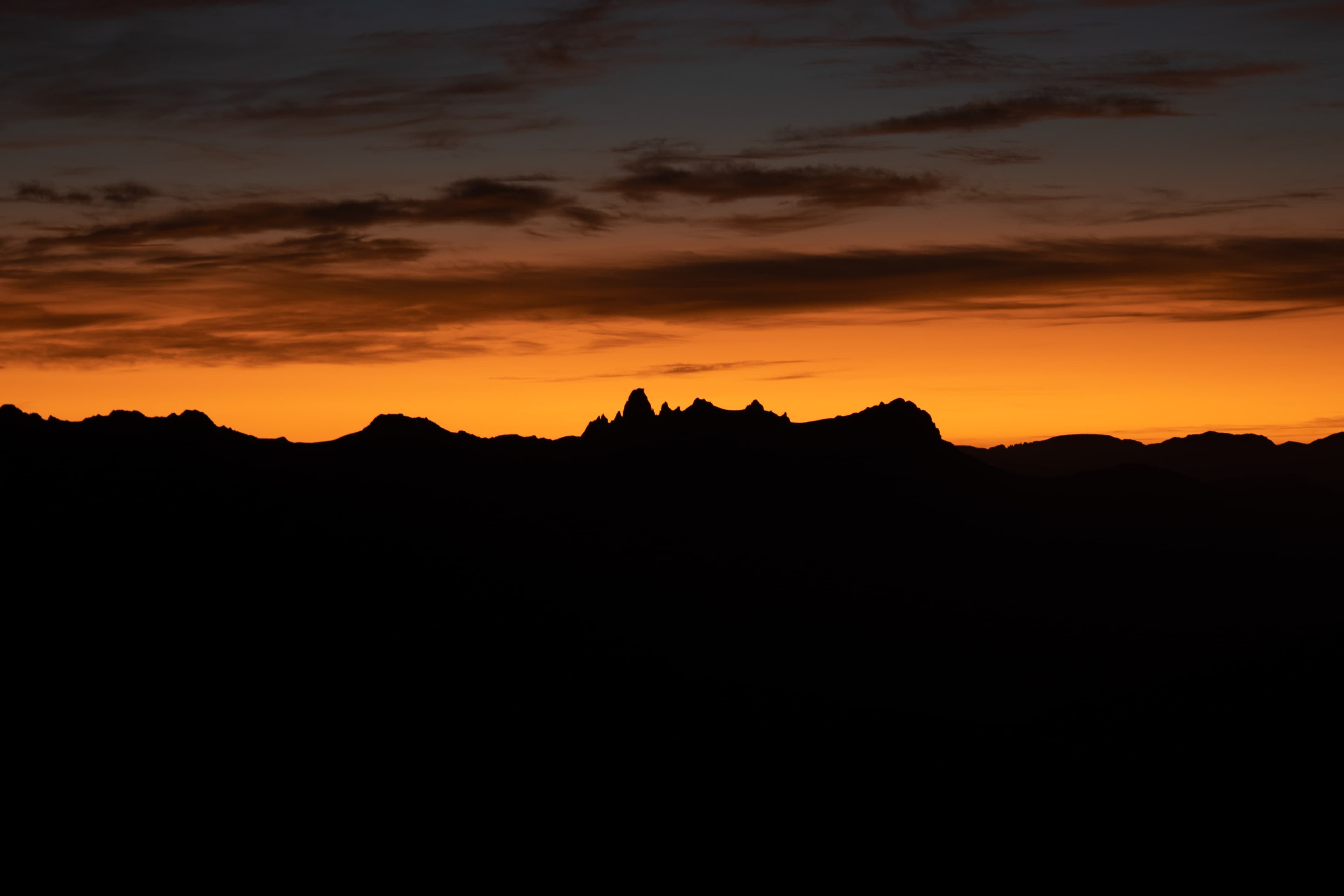Sunrise overlooking Federation Peak. The distinct hook of the peak makes it unmistakable.